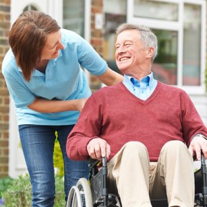 Picture of carer with an elderly gentleman who is using equity release to pay for his care