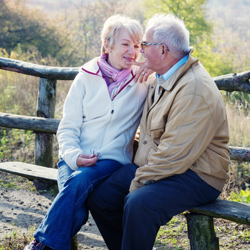 Old Couple photograph sitting together enjoying time together after organising their equity release