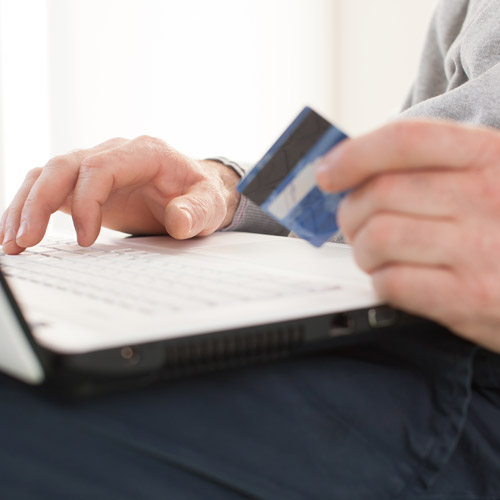 Person paying bills online with credit card