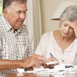 Older couple looking worried about bills and needing to organise equity release